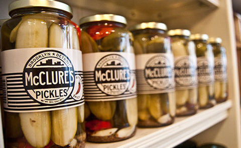 mcclure's pickles lined up on a shelf 