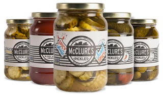 Jars of McClure's pickles with visible labels on a white background