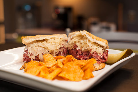 picture of sandwich with sauerkraut and pickles